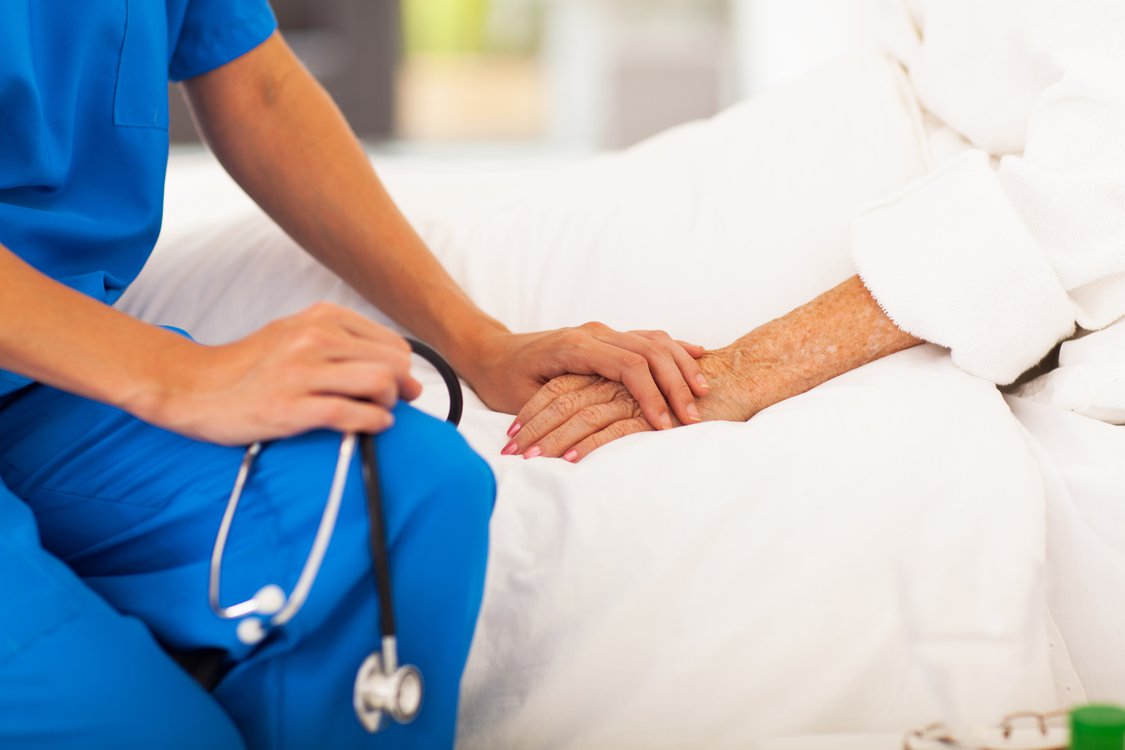 stock-photo-medical-doctor-holing-senior-patient-s-hands-and-comforting-her-126288149.jpg
